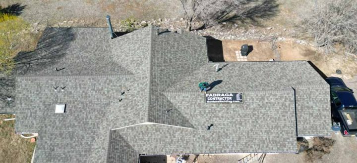 Roof Inspection After Installation Contractor performing a thorough inspection of a newly installed roof on a single-family home, ensuring quality control.