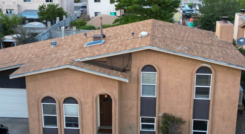 Aerial view of a suburban home featuring a newly installed roof, capturing the finished look of a residential roofing project.