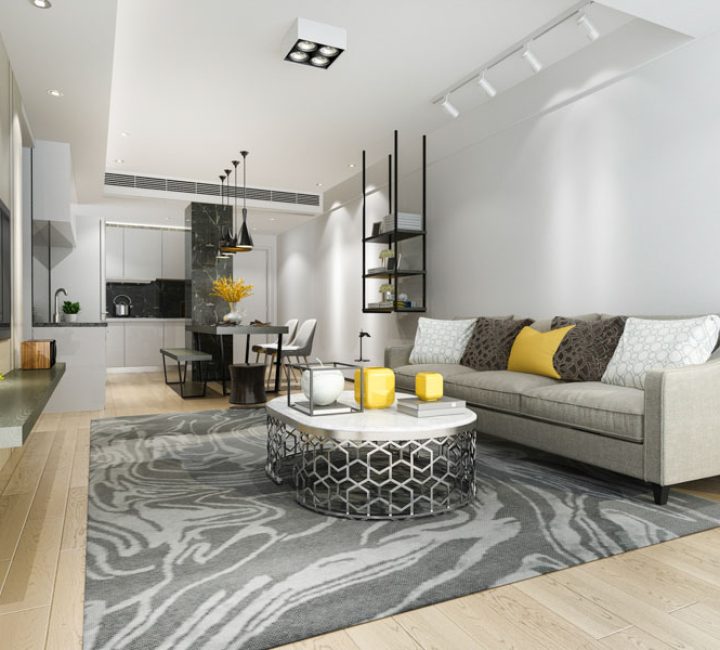 Modern Open Concept Living and Kitchen Area Open plan living space with a modern kitchen, dining area, and living room, featuring gray and white decor, wood flooring, and contemporary furniture.